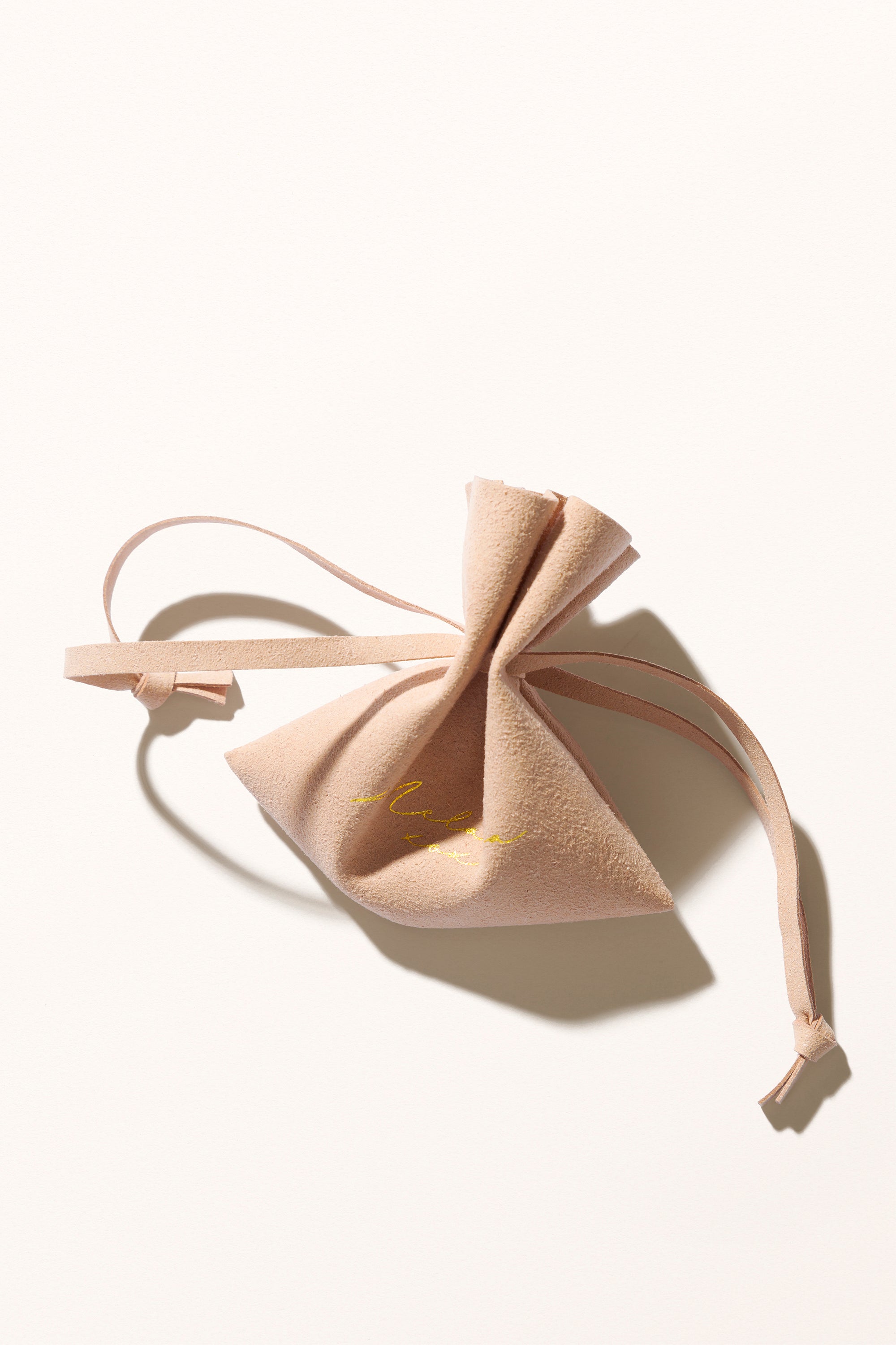 Blush-toned luxury packaging for Melana jewelry.